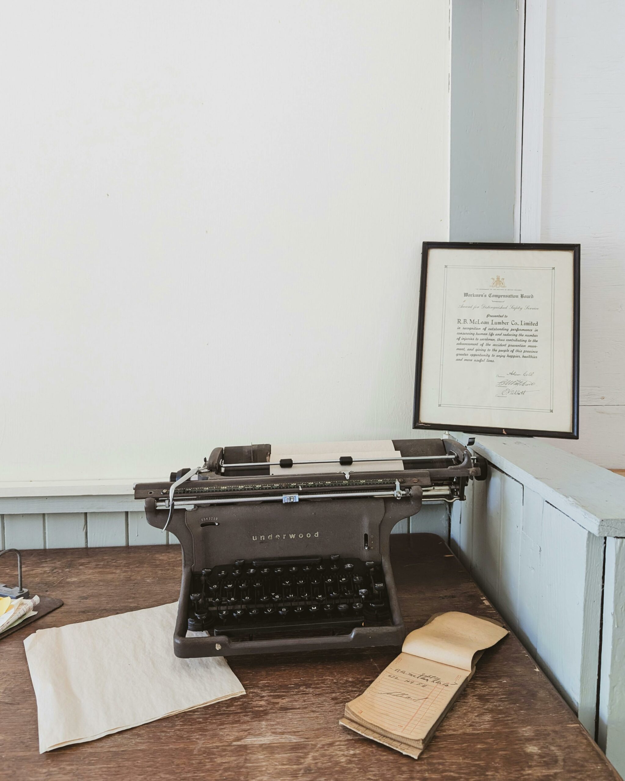 Classic typewriter on a rustic wooden desk in a nostalgic office setting.